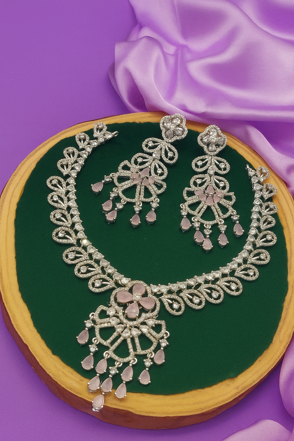 Elegant silver-plated necklace set with cubic zirconia and pink teardrop stone earrings for bridal and party wear