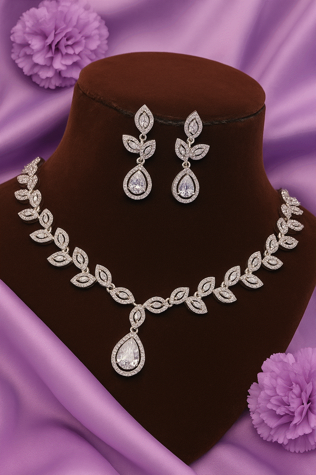 Luxury CZ intimate jewelry set with silver rhodium leaf vine bridal necklace and teardrop pendant earrings on velvet display