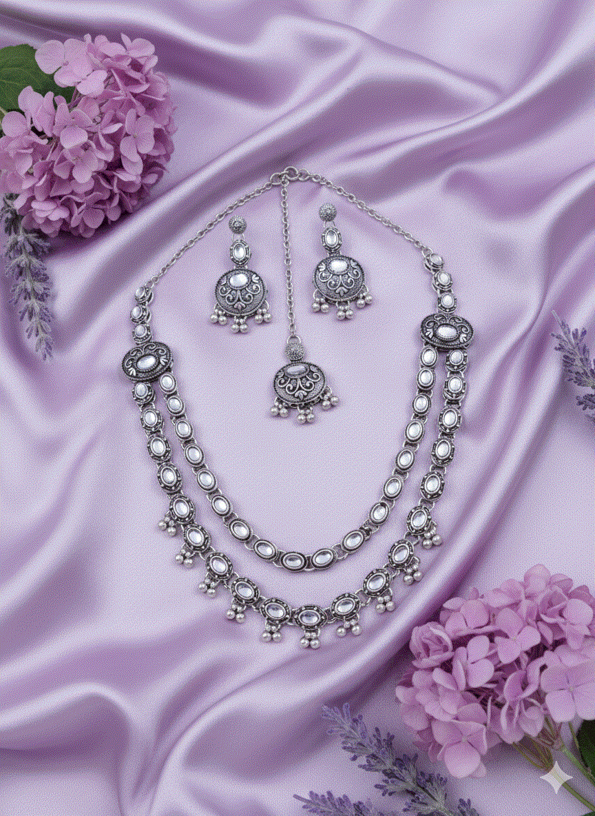 Heritage Intimate Jewelry oxidized silver necklace set with long temple pendant and pearl drops on purple satin background