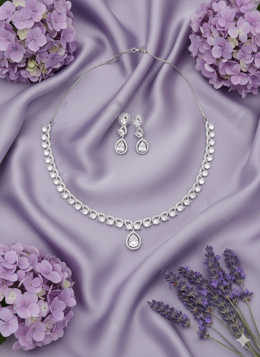 Luxury intimate jewelry clear CZ teardrop choker and matching drop earrings on purple silk with flowers