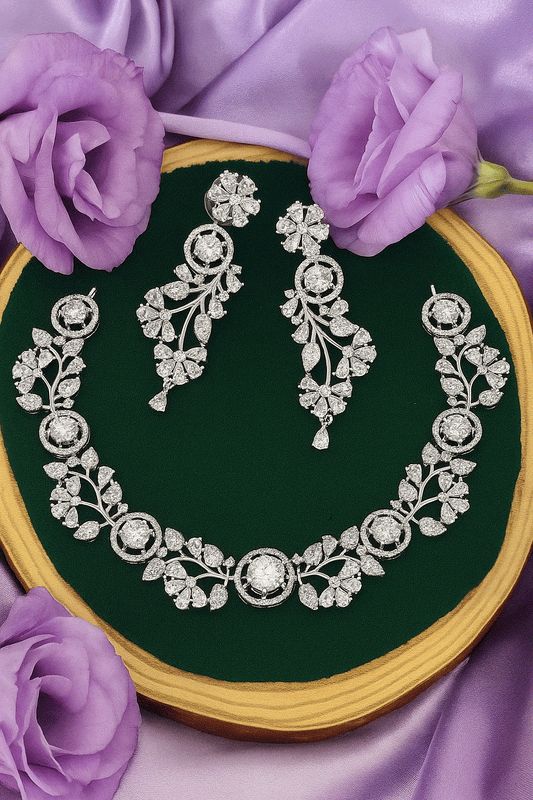 Intimate Luxury CZ Diamond Necklace Set with earrings in silver-plated floral vine design on green velvet background with purple flowers