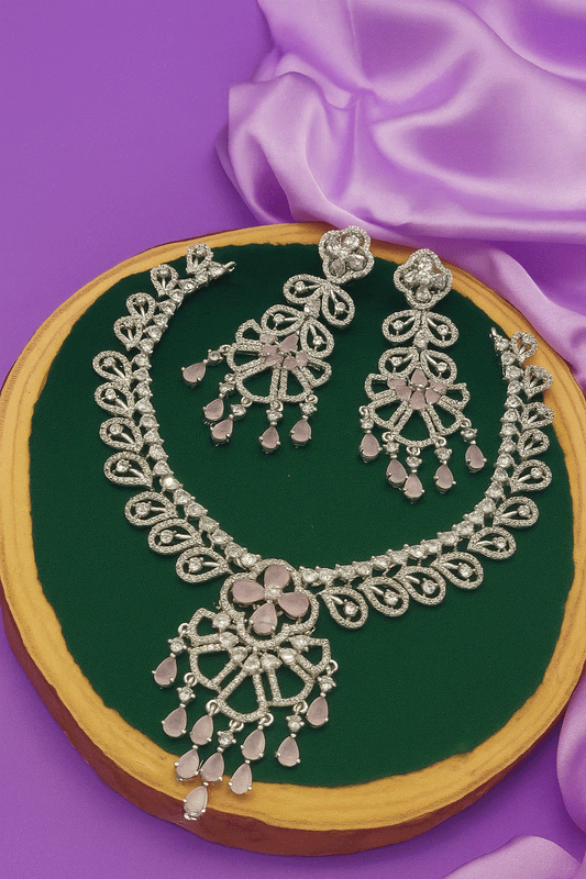 Elegant silver-plated necklace set with cubic zirconia and pink teardrop stone earrings for bridal and party wear