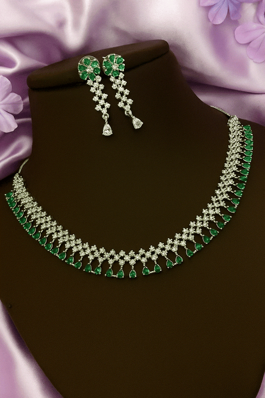 Luxury emerald green and diamond-cut cubic zirconia bridal necklace and earring set on display