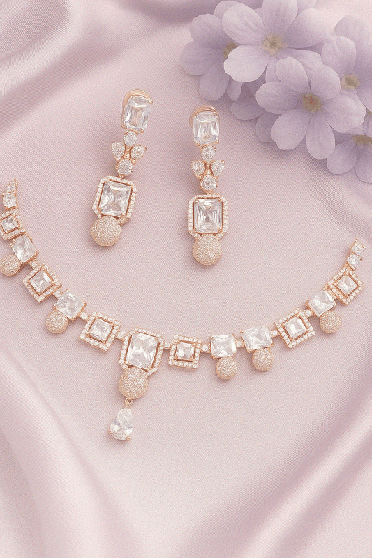 Luxury CZ Intimate Jewelry Set with rose gold geometric bridal necklace and diamond look earrings on pink satin background