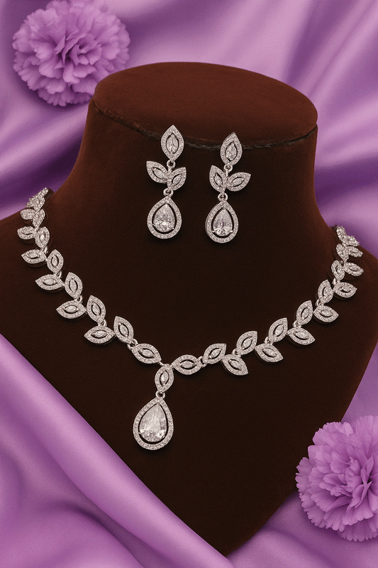 Luxury CZ intimate jewelry set with silver rhodium leaf vine bridal necklace and teardrop pendant earrings on velvet display