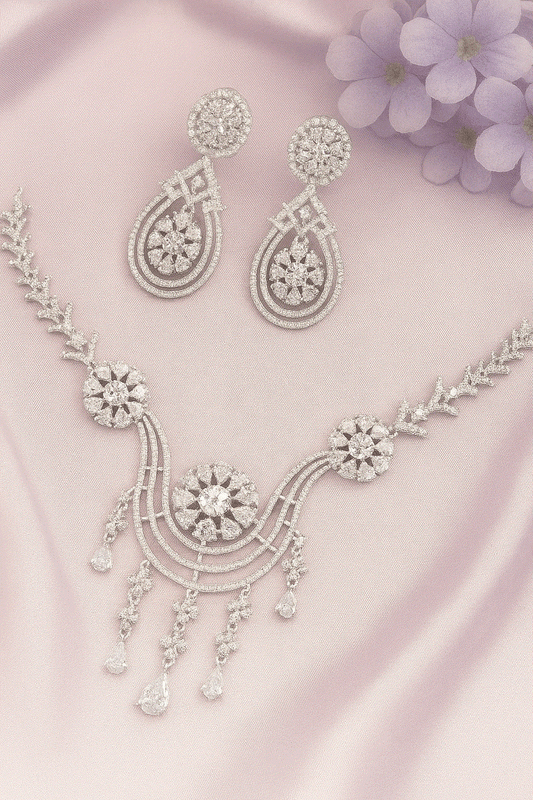 Luxury CZ Intimate Jewelry Set with rhodium-plated floral bridal necklace and chandelier earrings on pink satin background