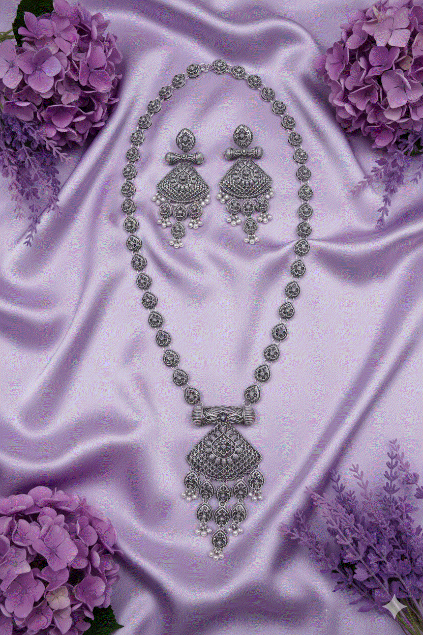 Heritage Intimate Jewelry oxidized silver look necklace set with traditional temple shield pendant and pearl drops on purple satin background