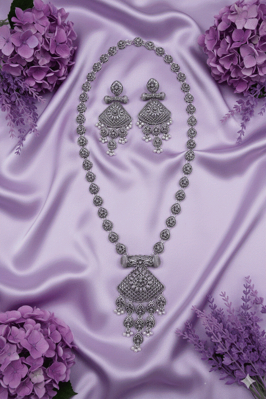 Heritage Intimate Jewelry oxidized silver look necklace set with traditional temple shield pendant and pearl drops on purple satin background