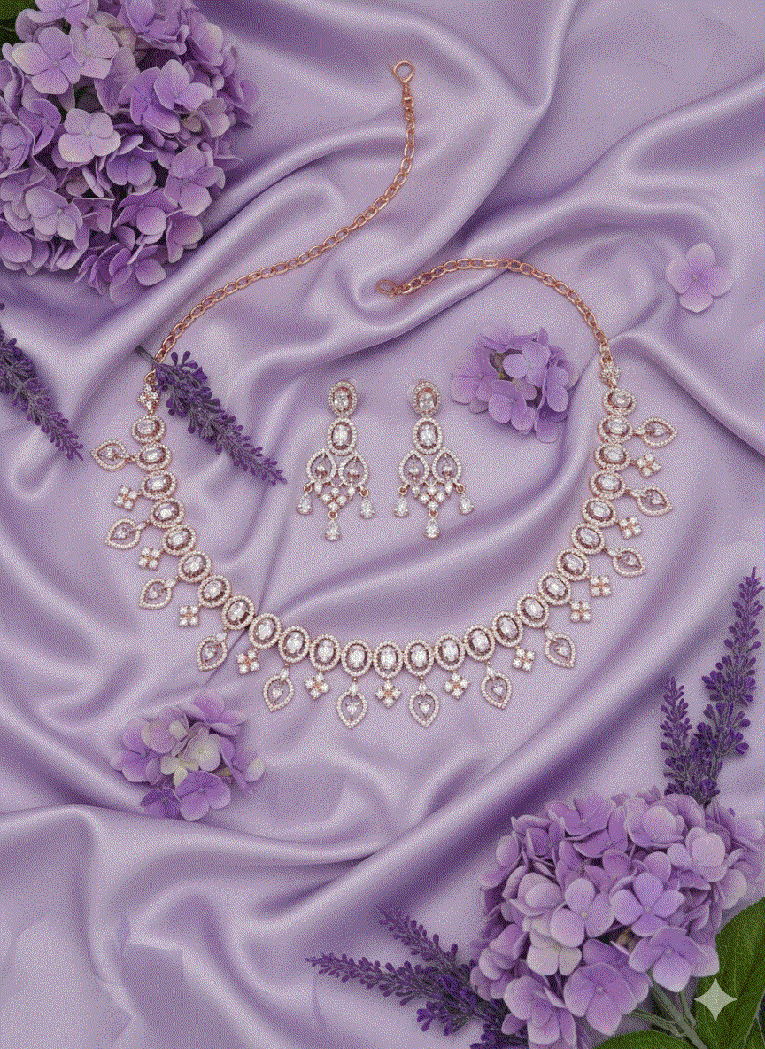 Intimate Jewelry rose gold plated oval link necklace set with matching chandelier earrings on purple satin background