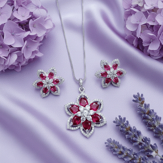 Romantic intimate jewelry set with red floral pendant and matching earrings, luxury CZ stones, rhodium plated on purple silk background