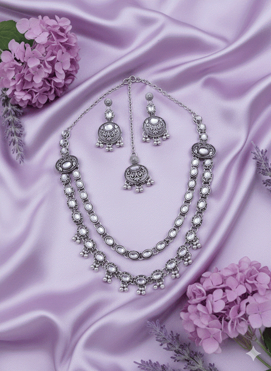 Heritage Intimate Jewelry oxidized silver necklace set with long temple pendant and pearl drops on purple satin background
