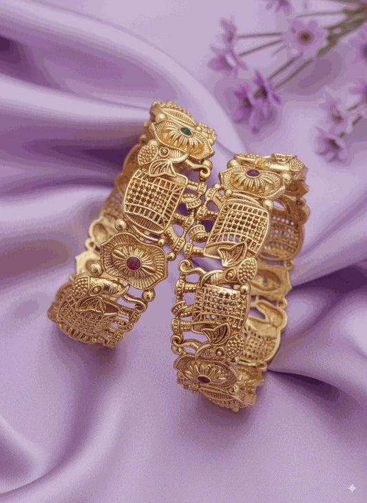 Luxury gold-tone intricate bangles on purple satin with small flowers
