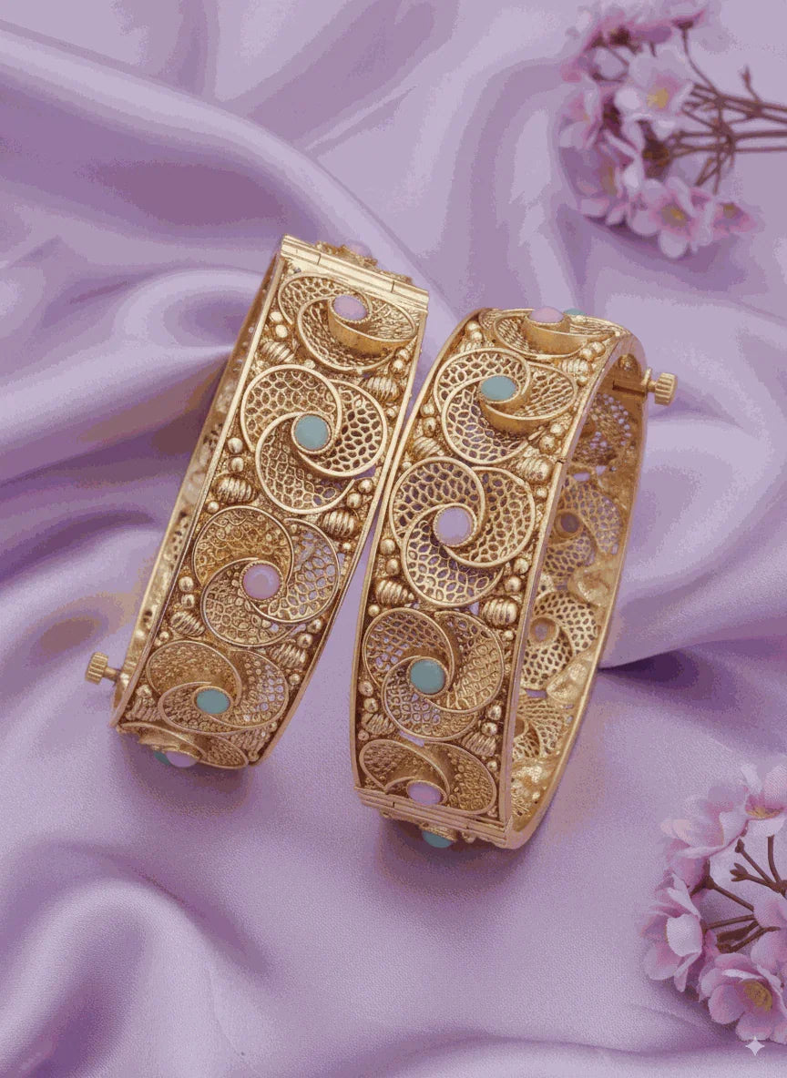 Enchanting Intimate Jewelry gold plated filigree bangles with pink and mint enamel on lavender fabric