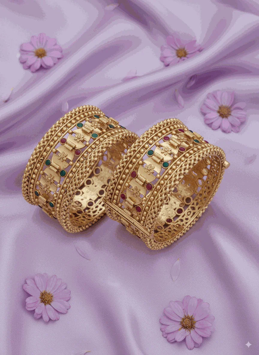 Enchanting intimate jewelry antique gold plated filigree bangle set with pastel enamel accents on lavender fabric background