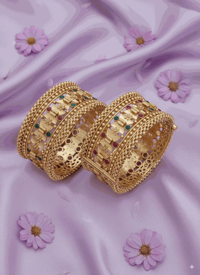 Enchanting intimate jewelry antique gold plated filigree bangle set with pastel enamel accents on lavender fabric background