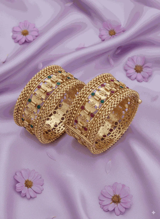 Enchanting intimate jewelry antique gold plated filigree bangle set with pastel enamel accents on lavender fabric background