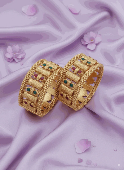 Opulent Intimate Jewelry gold-plated bridal bangles with ruby and emerald Kundan-style gemstones on satin background