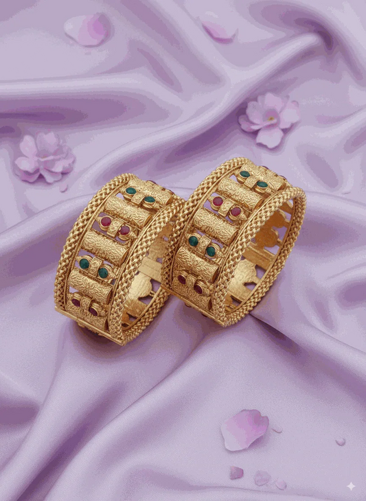 Opulent Intimate Jewelry gold-plated bridal bangles with ruby and emerald Kundan-style gemstones on satin background
