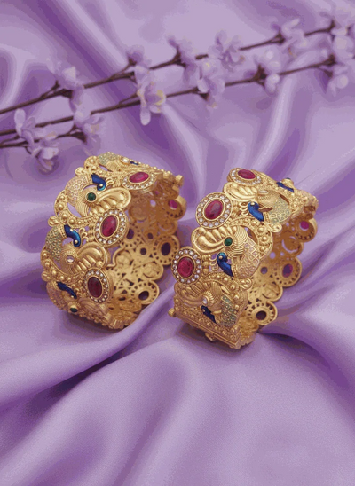 Royal Peacock Intimate Jewelry Bangles gold plated with ruby emerald CZ stones and peacock design on purple fabric background