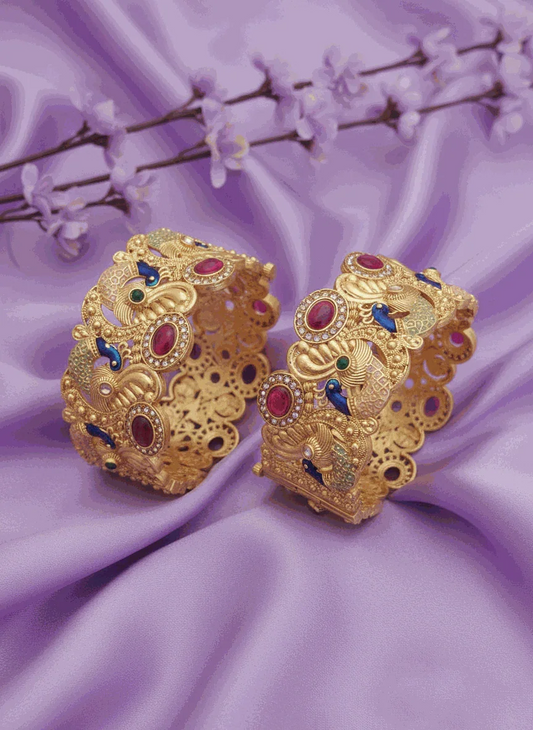 Royal Peacock Intimate Jewelry Bangles gold plated with ruby emerald CZ stones and peacock design on purple fabric background