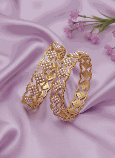 Luxury pearl intimate jewelry bangles gold plated bridal kada set with lattice design on pink satin background