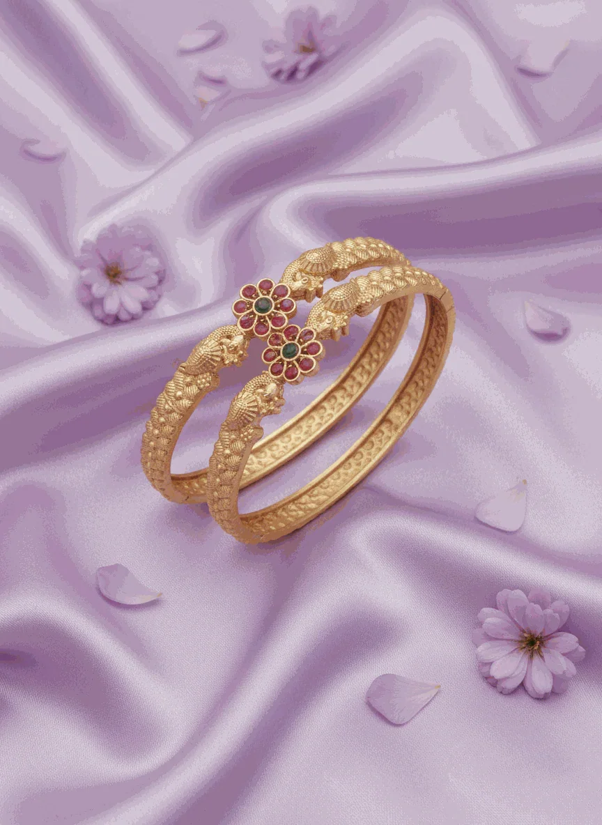 Matte gold plated traditional floral jewelry bangles with ruby and emerald stones on purple silk background