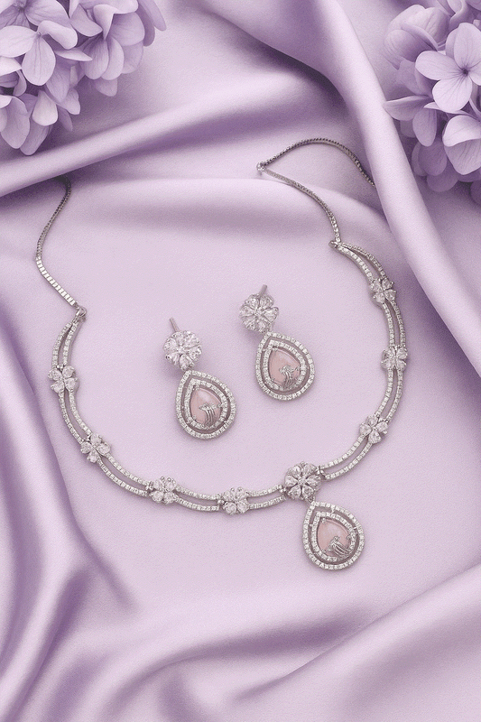 Romantic Intimate Jewelry floral drop necklace and earrings set with pink stones and CZ on purple silk background
